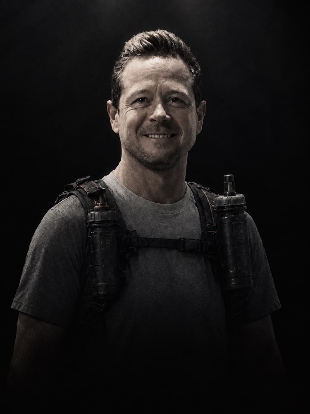 Darren Ware, ULTRALABS founder and coach, in a running vest against a black background